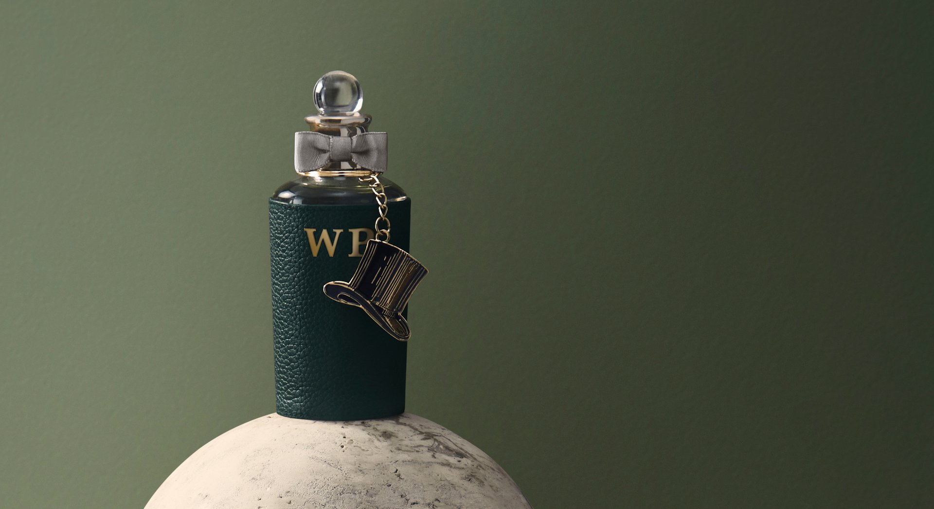 Personalised fragrance bottle with leather sleeve with gold initials and top hat charm