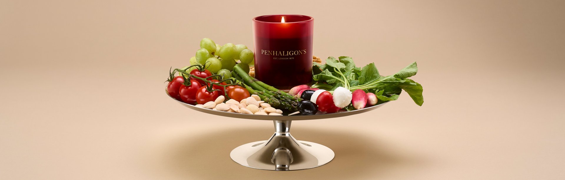 Red Penhaligon's candle on tray of fresh ingredients