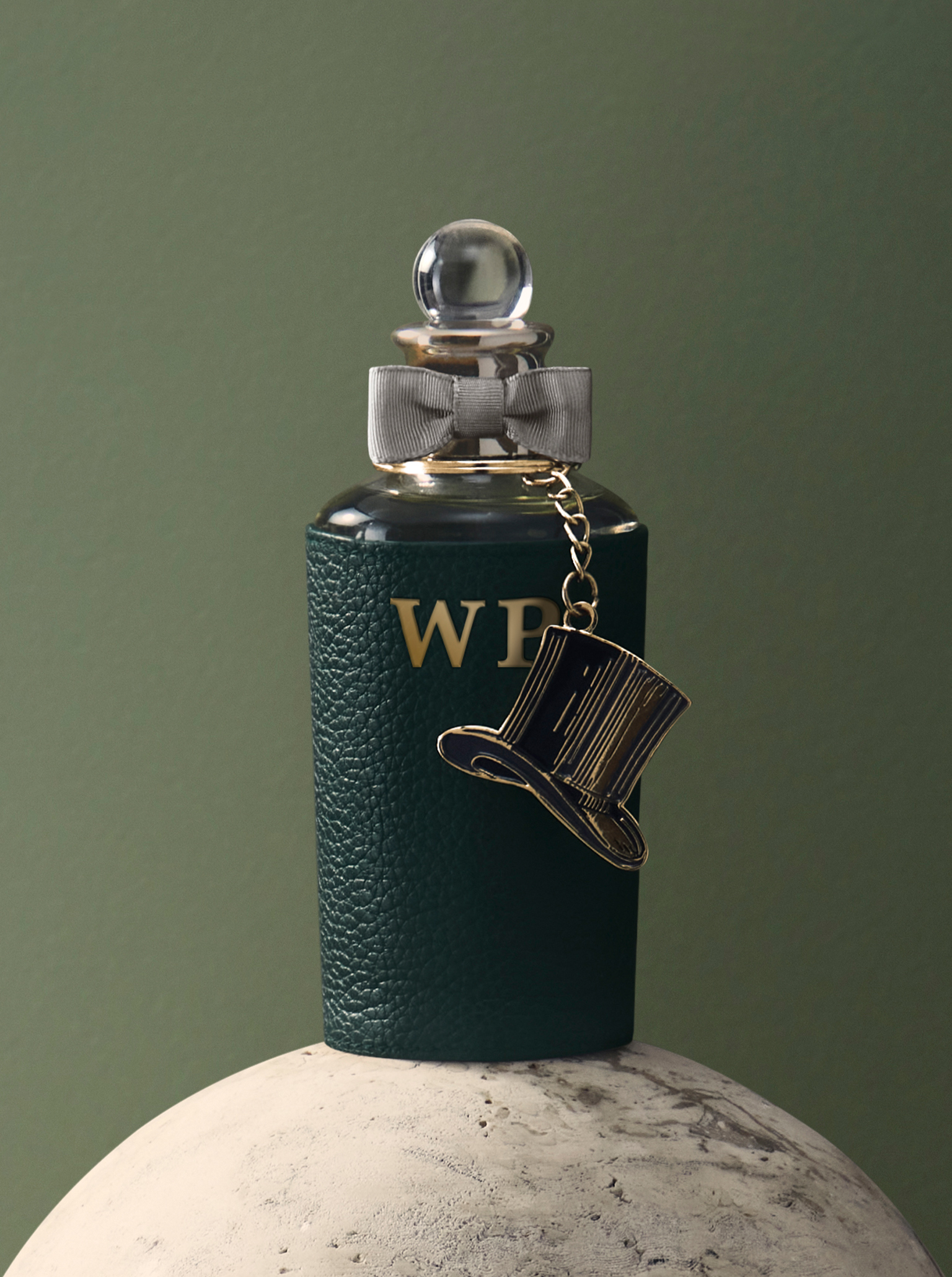 Fragrance with monogram green leather sleeve and top hat charm