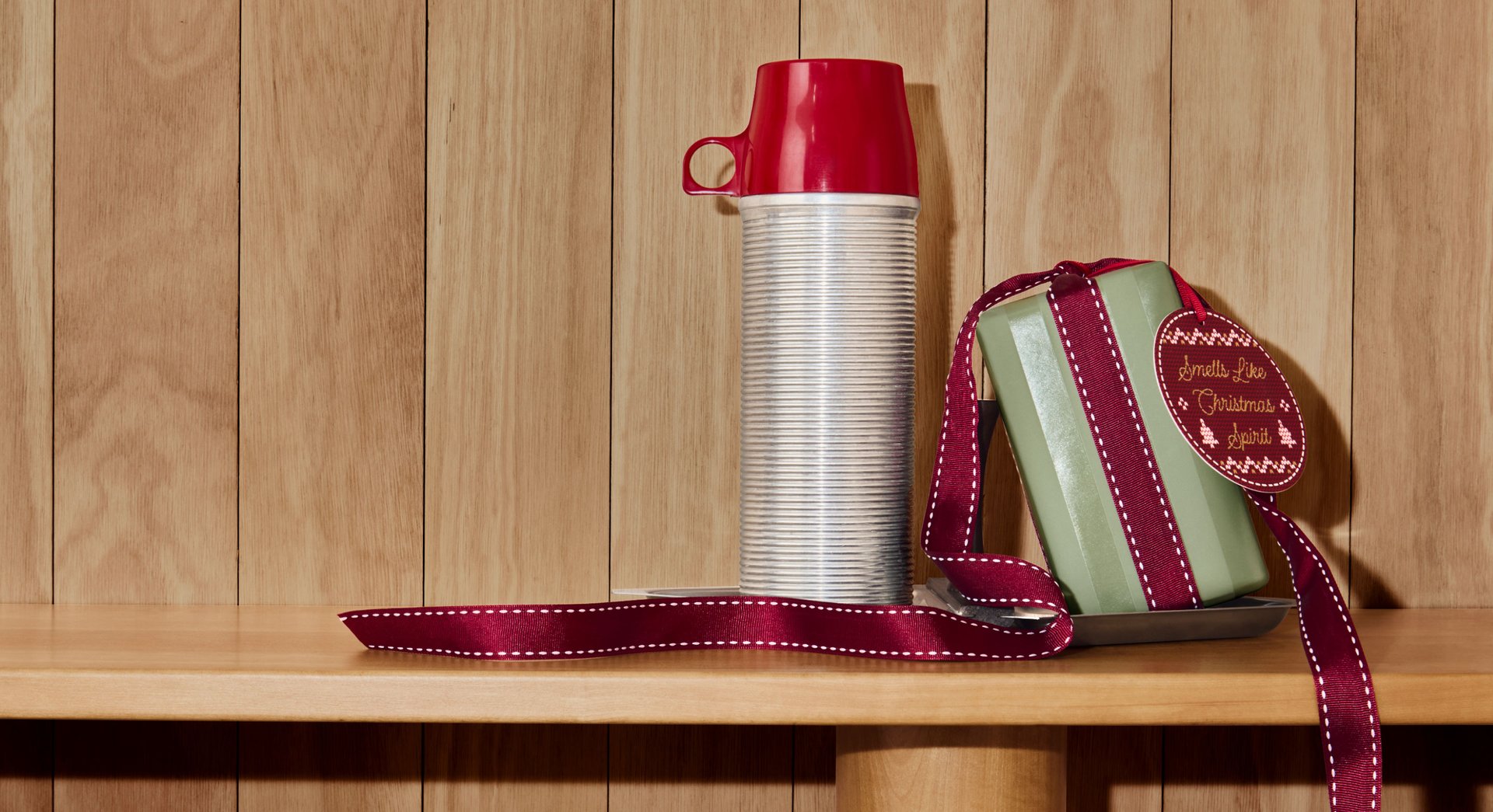 Vintage thermos and Penhaligon's gift box with red ribbon and gift tag