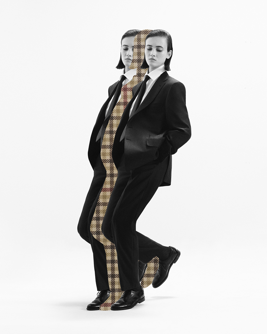 Man posing in tailored suit with herringbone cut out