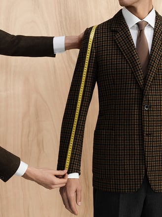 Man measuring suit sleeve
